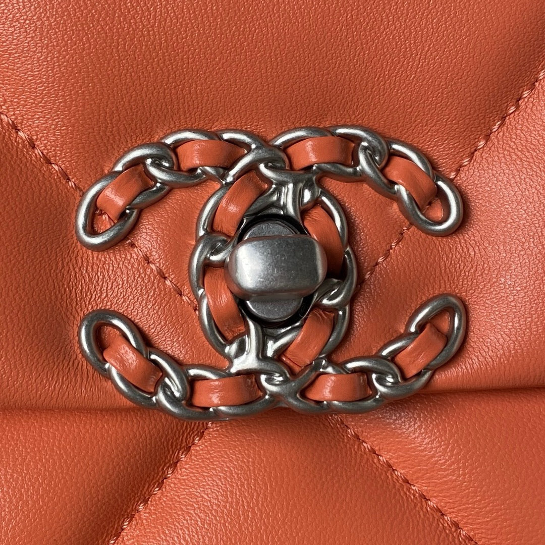 close up of silver chanel buckle of Orange chanel 19 handbag in lamb skin and silver hardware
