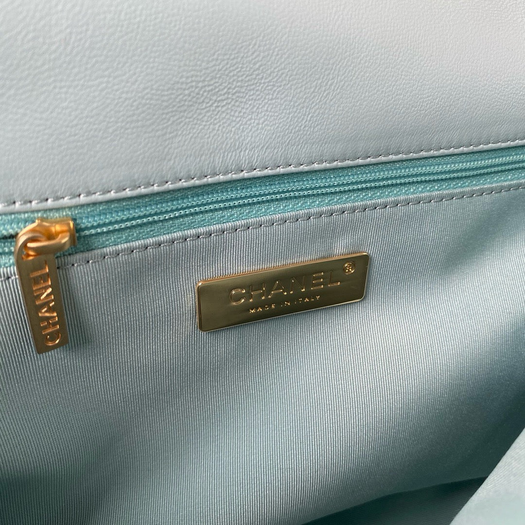 Inside gold hardware logo of chanel 19 handbag in aqua colour