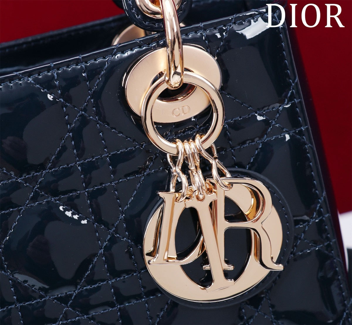 Light gold hardware of Lady Dior blue patent leather