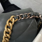 close up of gold and grey chain of Grey chanel 19 handbag in lamb skin gold hardware