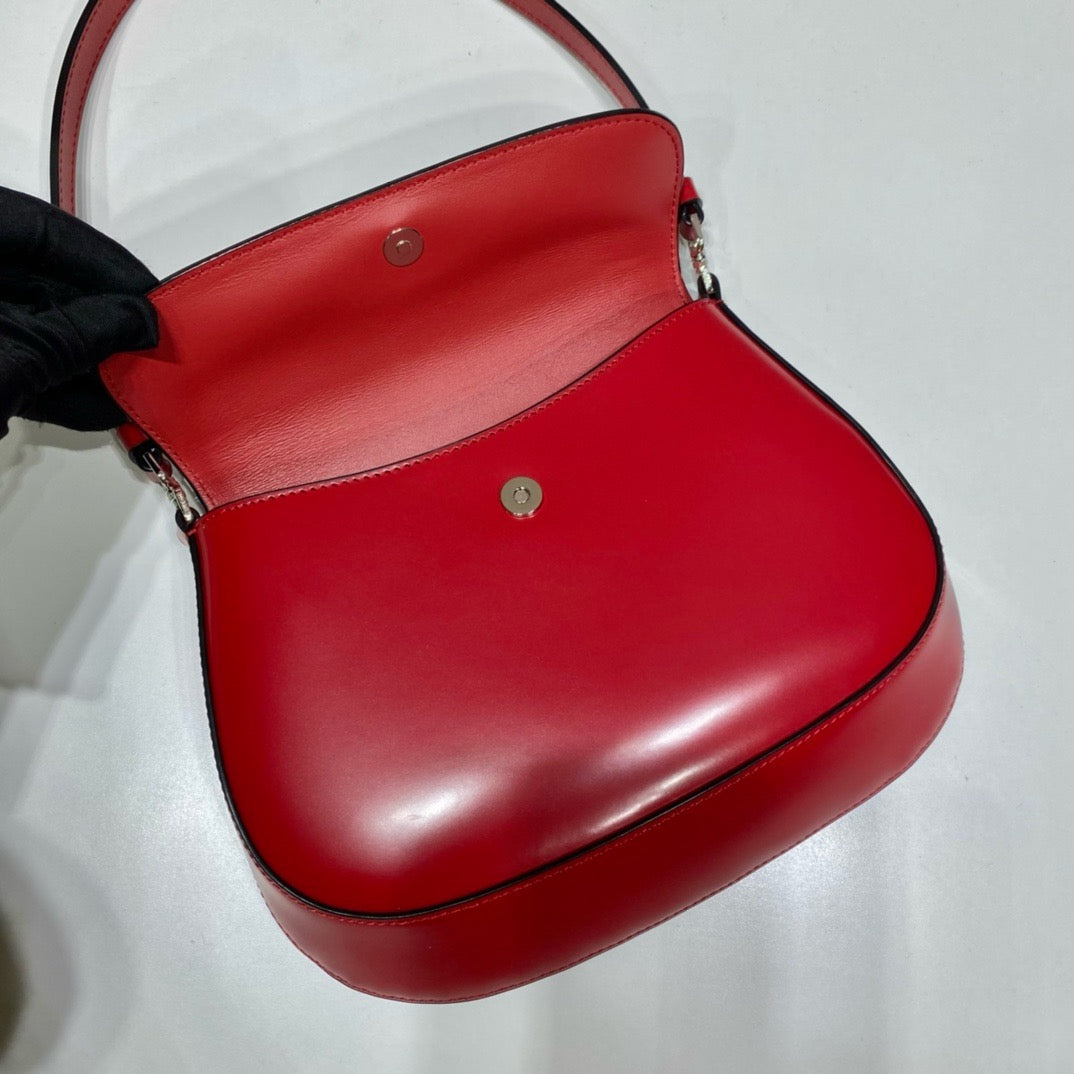flap opening of red prada cleo brushed leather shoulder bag