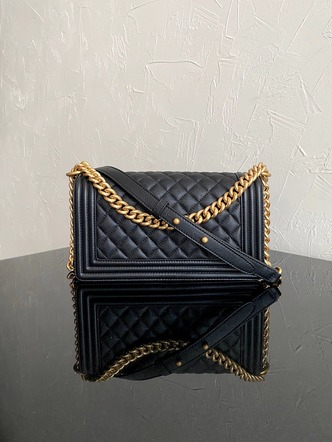 back of black boy chanel handbag with gold hardware