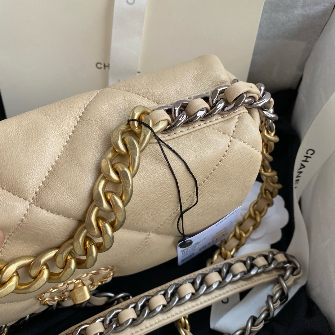 gold and silver tone hardware of Chanel 19 handbag in beige lamb skin
