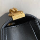 Gold hardware of black boy chanel handbag