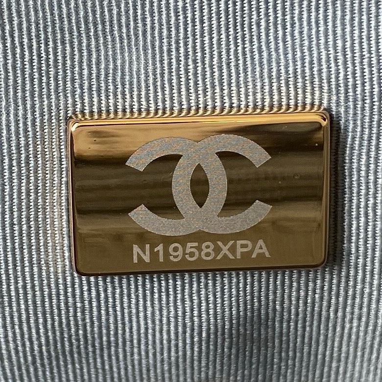 close up of microchip gold hardware of chanel 19 handbag