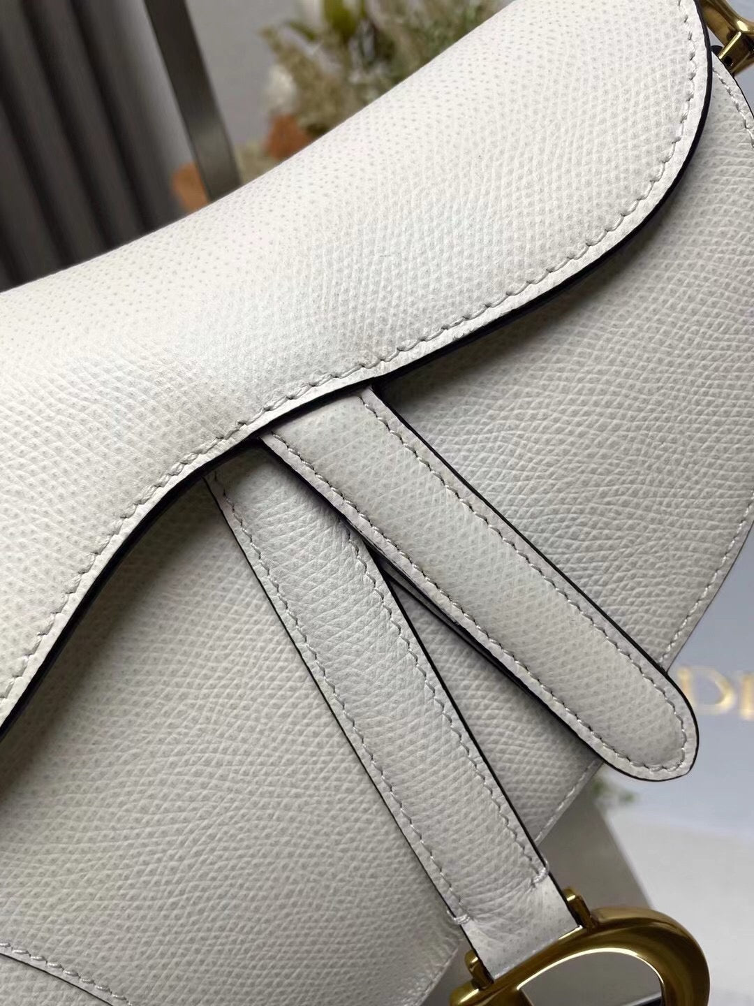 Close up of leather Dior Saddle Bag with Strap White Grained Calfskin
